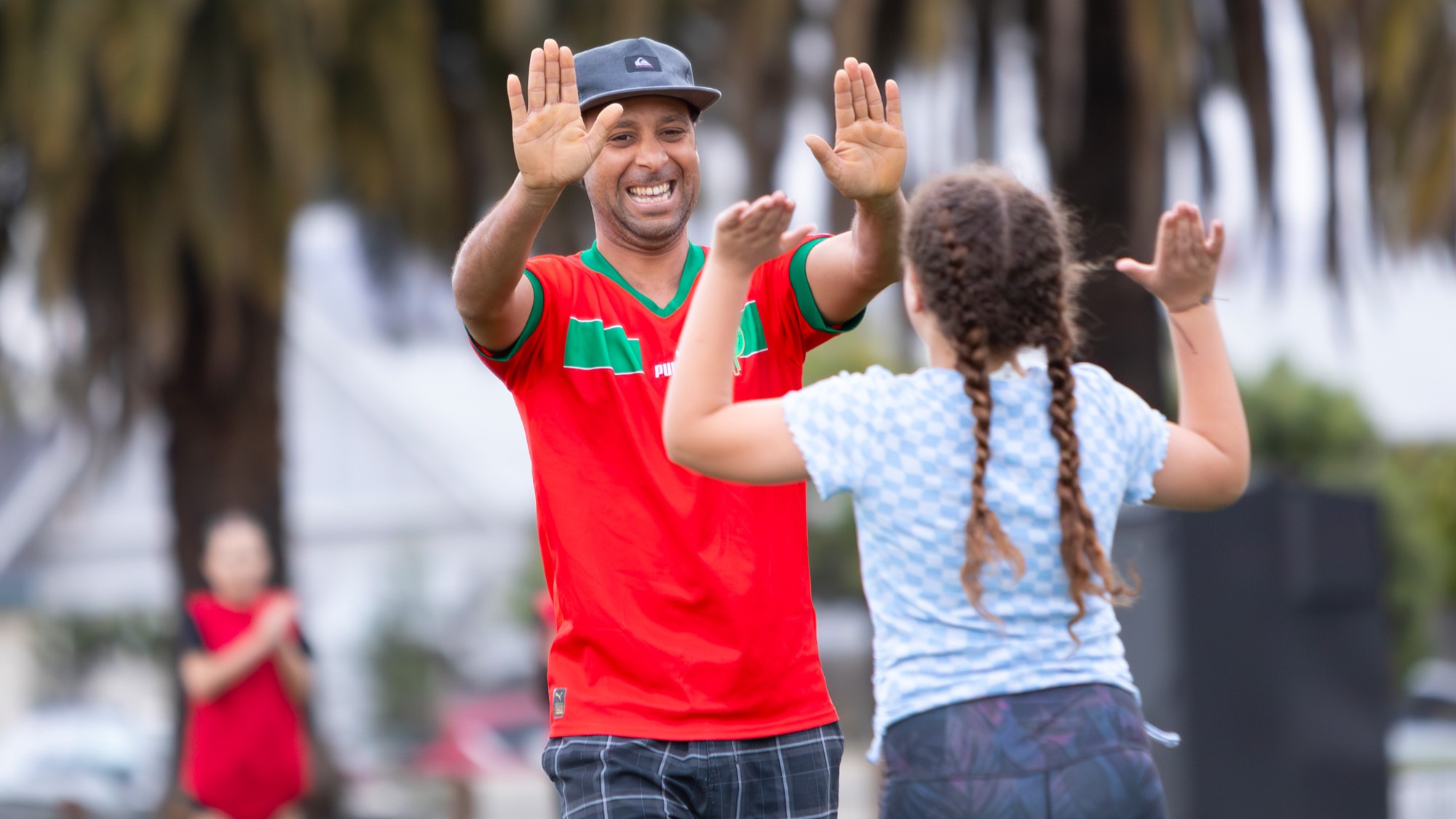 Dad and daughter hi-fiving