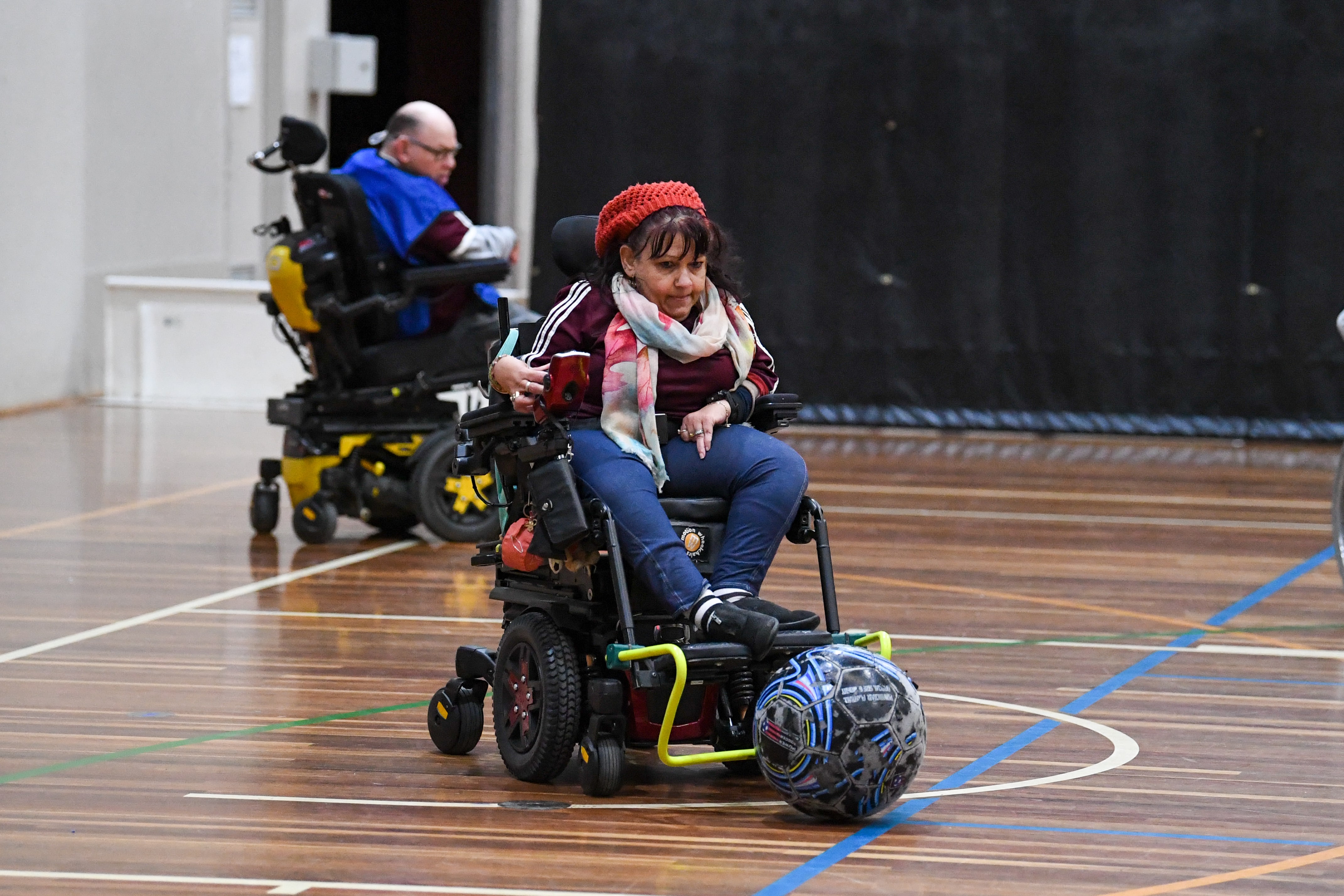 Wheelchair football player dribbling the ball