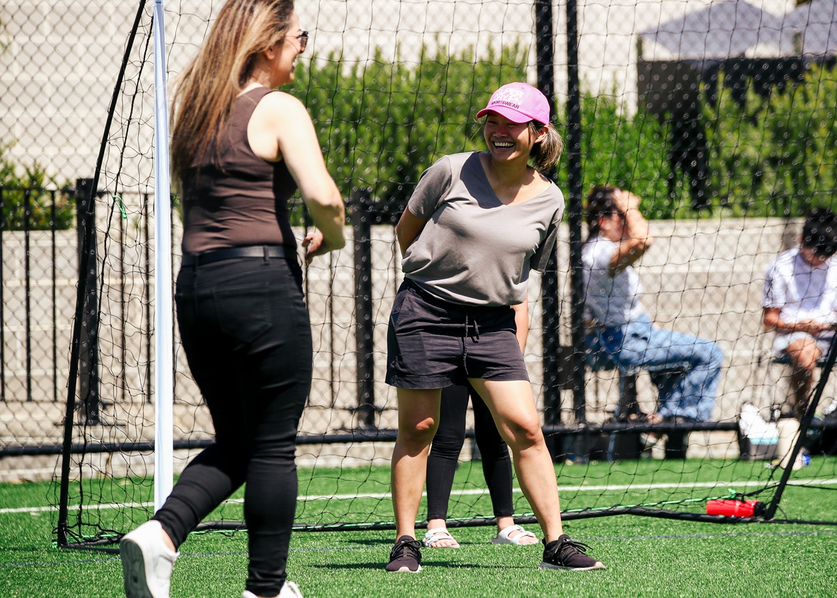 Women on a football pitch having fun in a casual environment. 