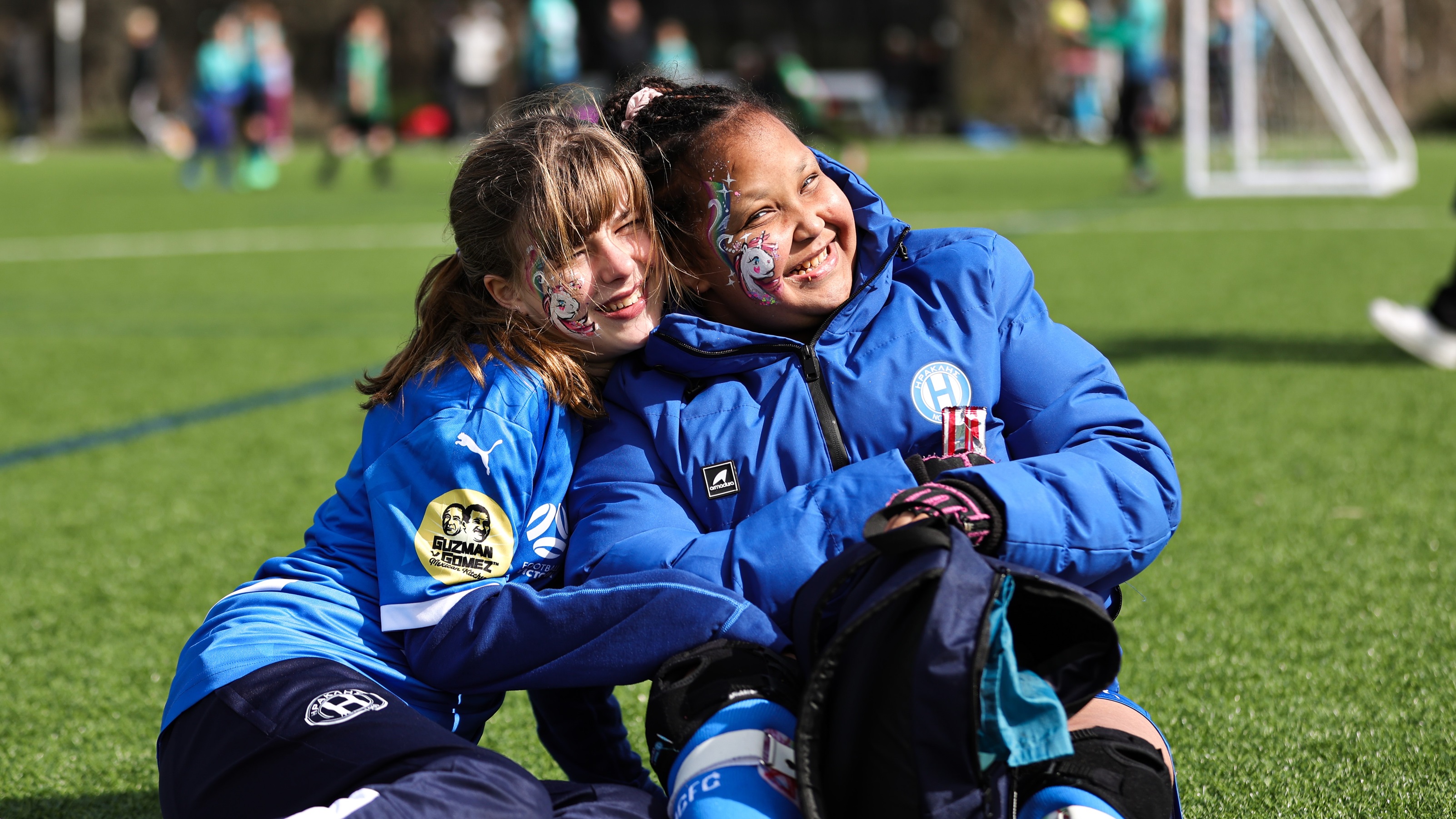 Two team mates posing for a photo, smiling at an All Abilities Gala day