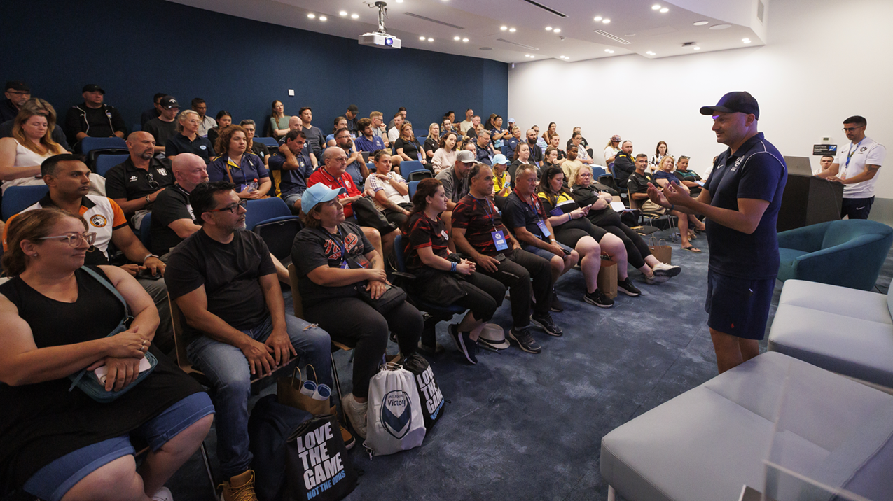 Football Victoria staff member presenting to clubs in an auditorium. 