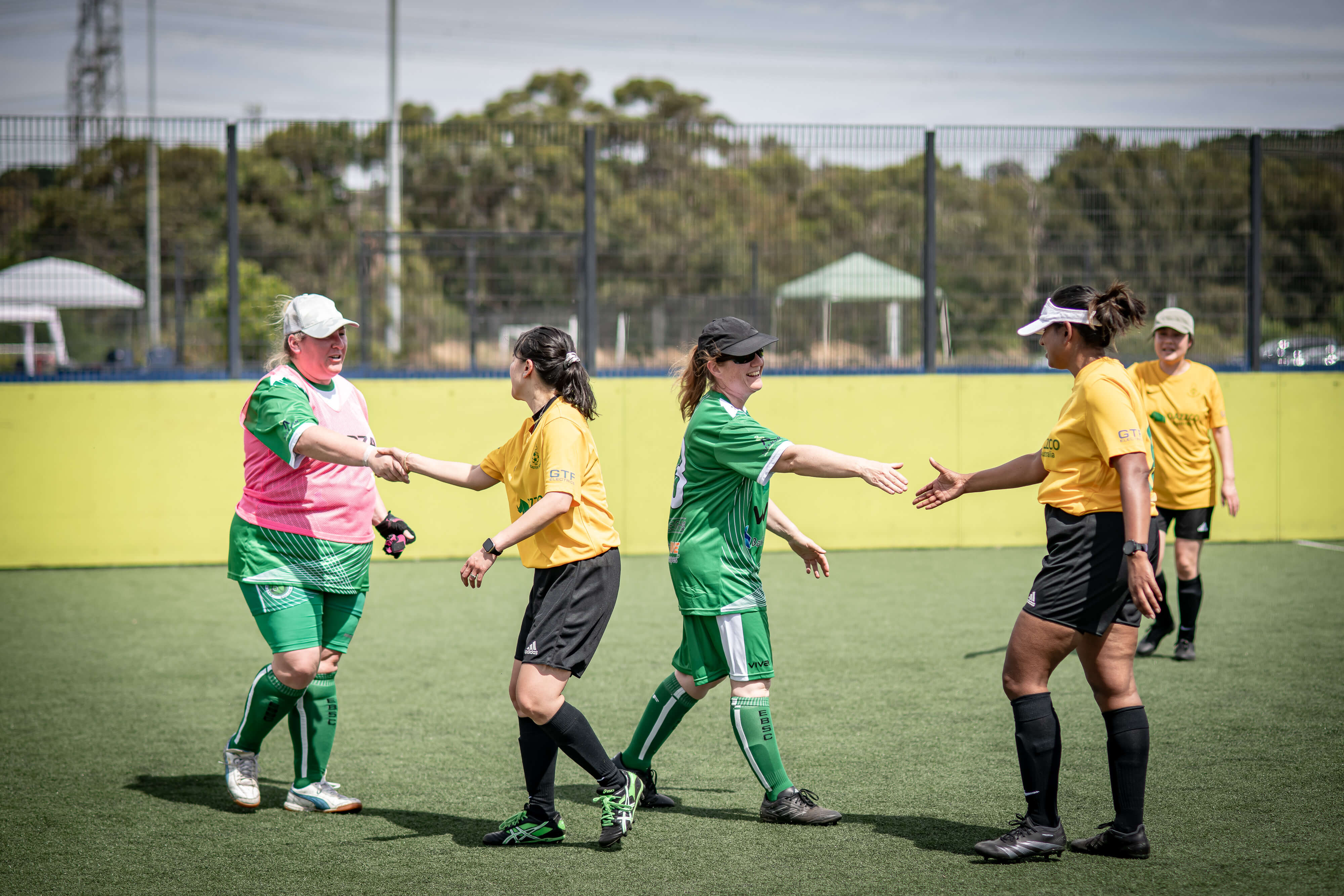 Women shaking hands after a soccer match