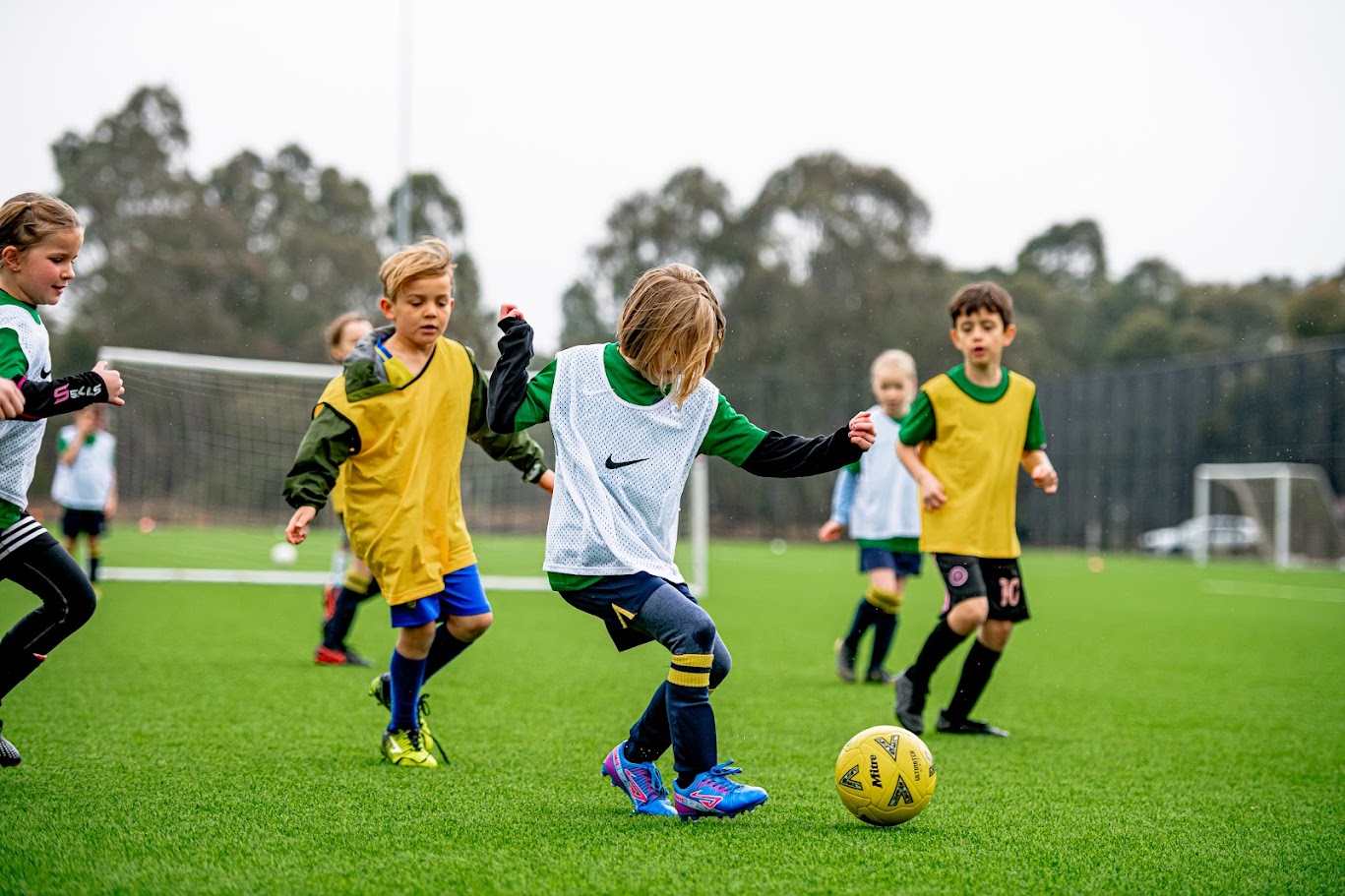 Children playing a soccer match outdoors