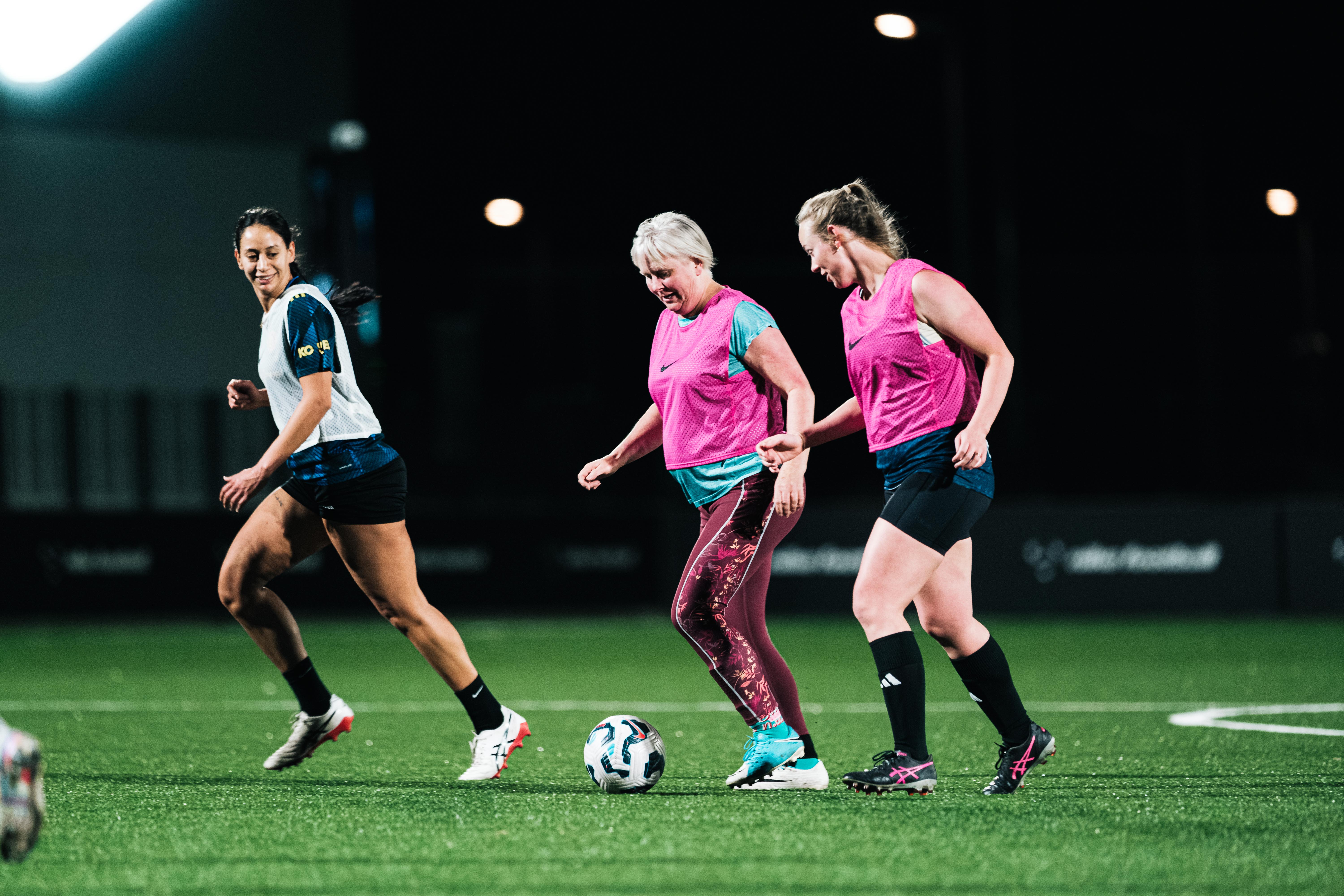 Women playing soccer