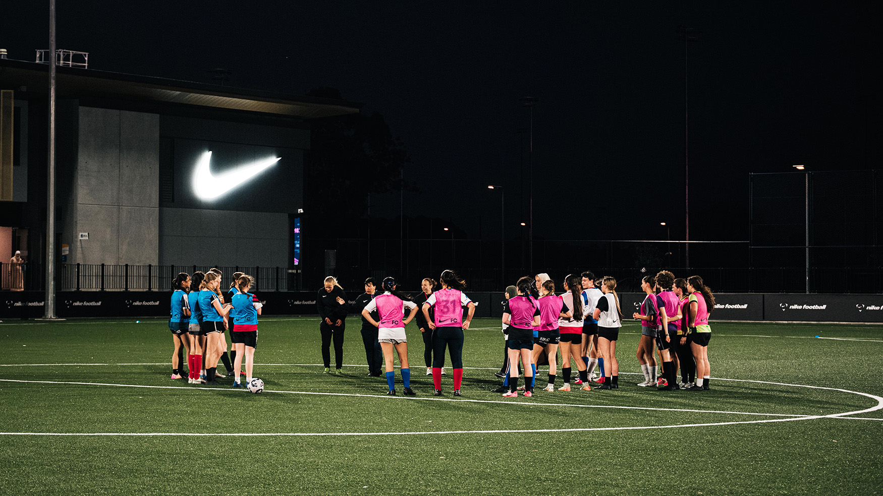Group of players at the Nike Rock Up & Play session at The Home of The Matildas at night.