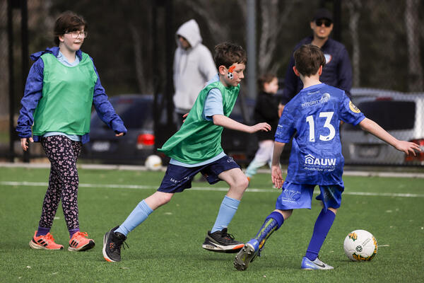two kids playing soccer